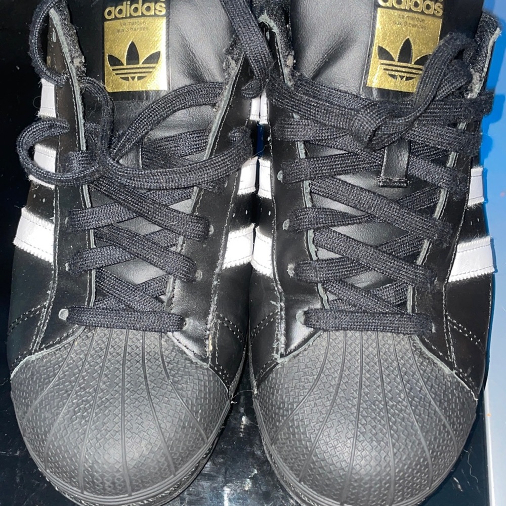 Adidas black and gold superstars